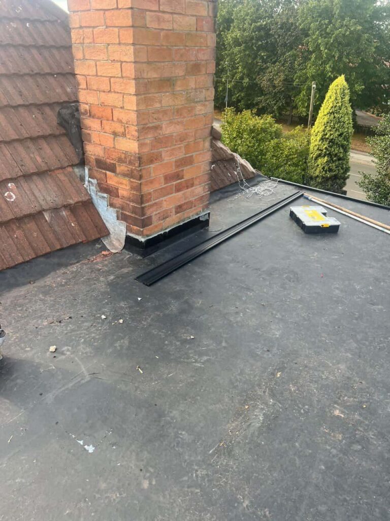 This is a photo of a flat roof which has just been repaired, there is also a chimney stack and some leadwork has also been dressed. Works carried out by Haverhill Roofing Repairs